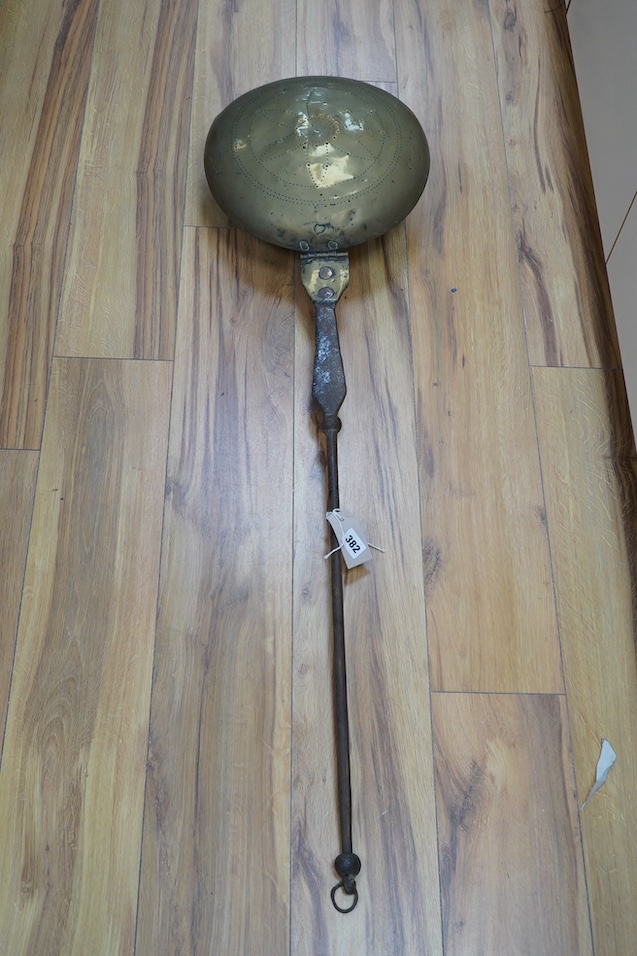A 17th century brass and iron warming pan, 112cm. Condition - poor